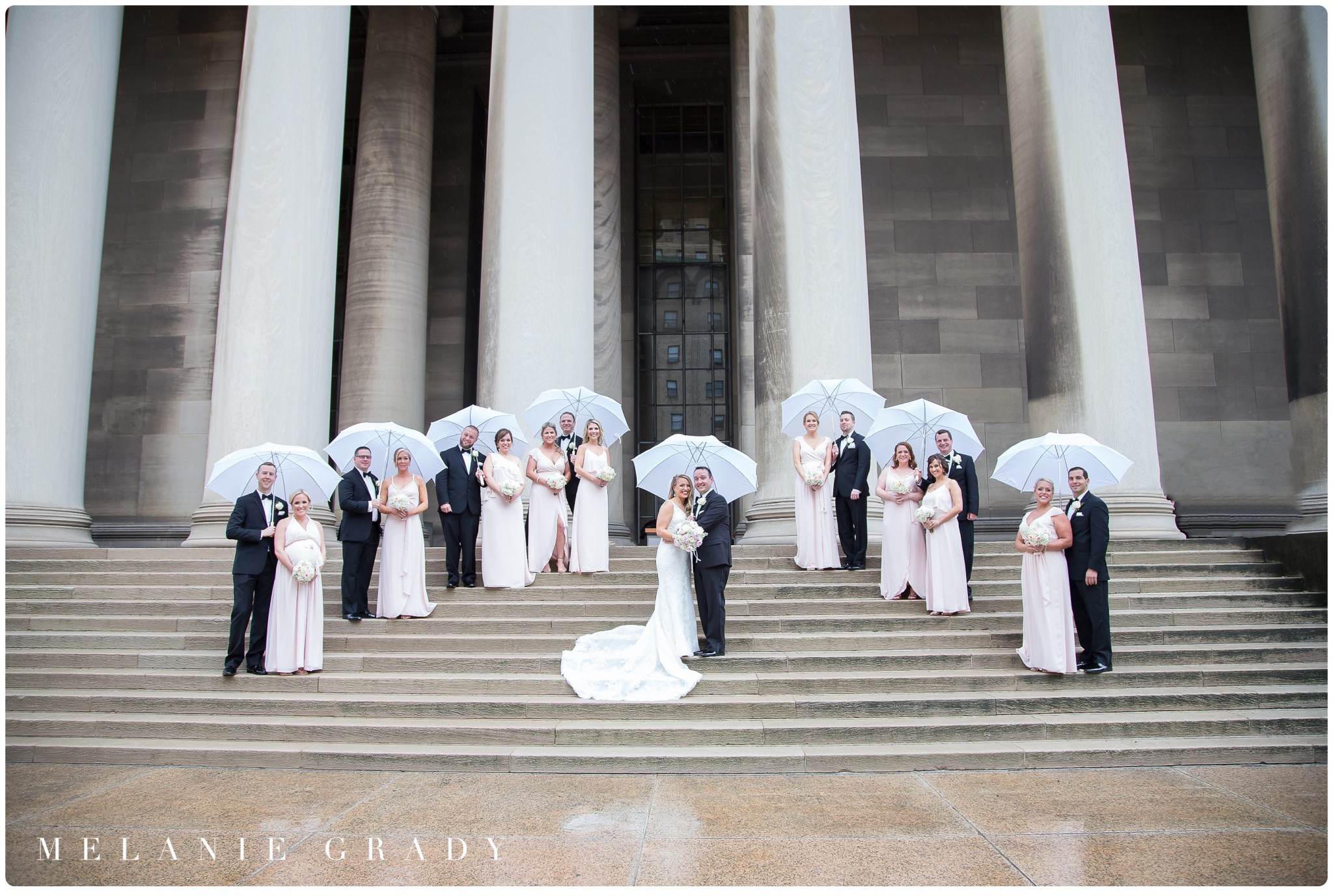 Carnegie Museum of Natural History Wedding, bridal portraits at the Mellon Institute columns, Rainy bridal party portraits, white golf umbrellas in wedding, blush bridesmaids dresses, black tux, bride and groom, grand stairs, nashville's premier wedding photographer, Melanie Grady, also travels for destination weddings all over the USA