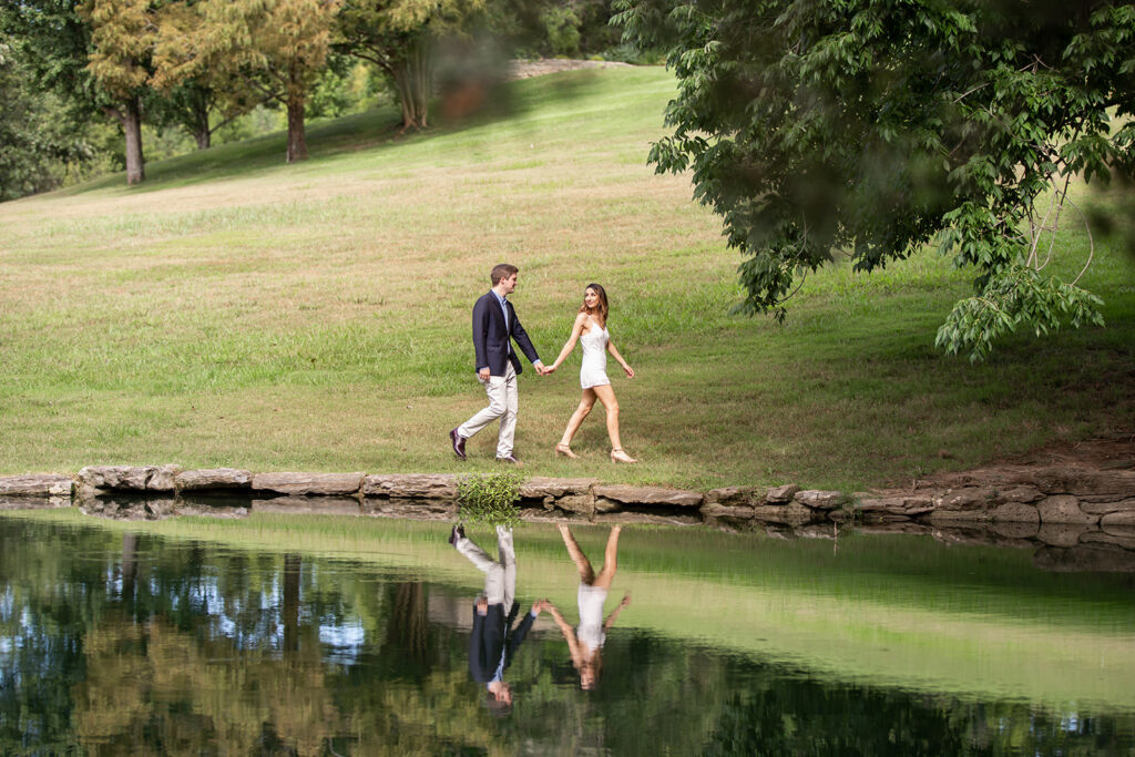 This young couple just got engaged at Cheekwood Botanical Gardens in Nashville and are walking beside the reflection pond.